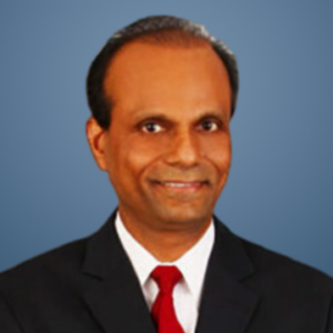 Dr. Bala Ganesh Gopurala smiling in a headshot against a blue background
