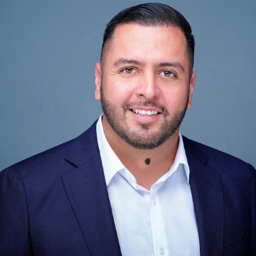 Man's headshot against Blue Background