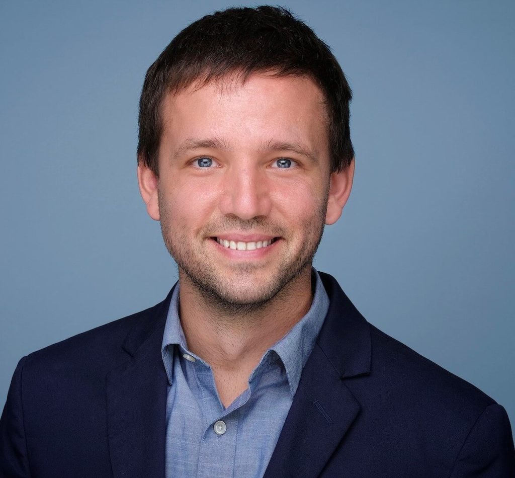 Man's headshot against blue background